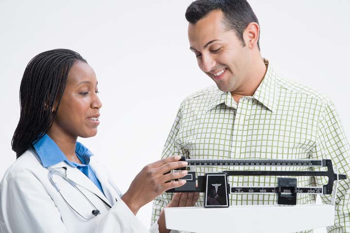 nurse checking mans weight